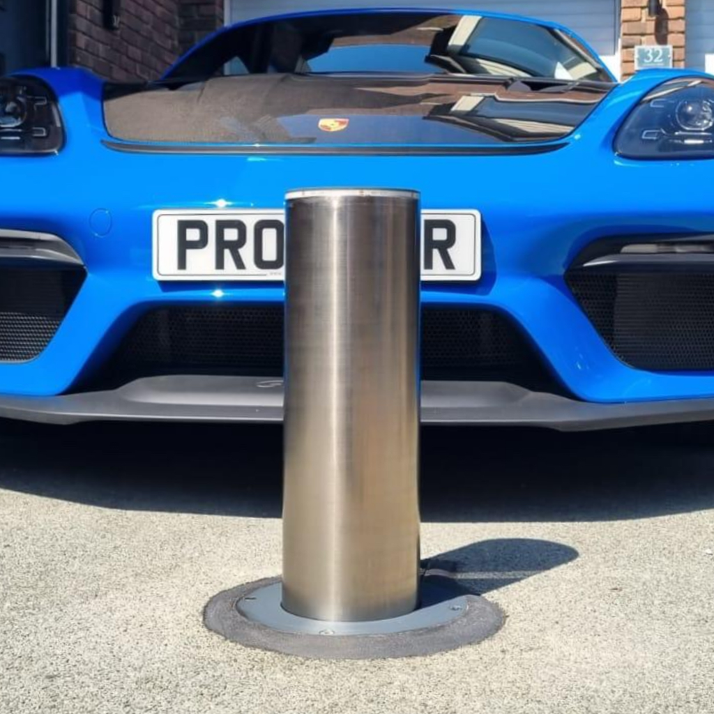 anchor automatic posts with a blue porsche in the background providing good driveway secuirty